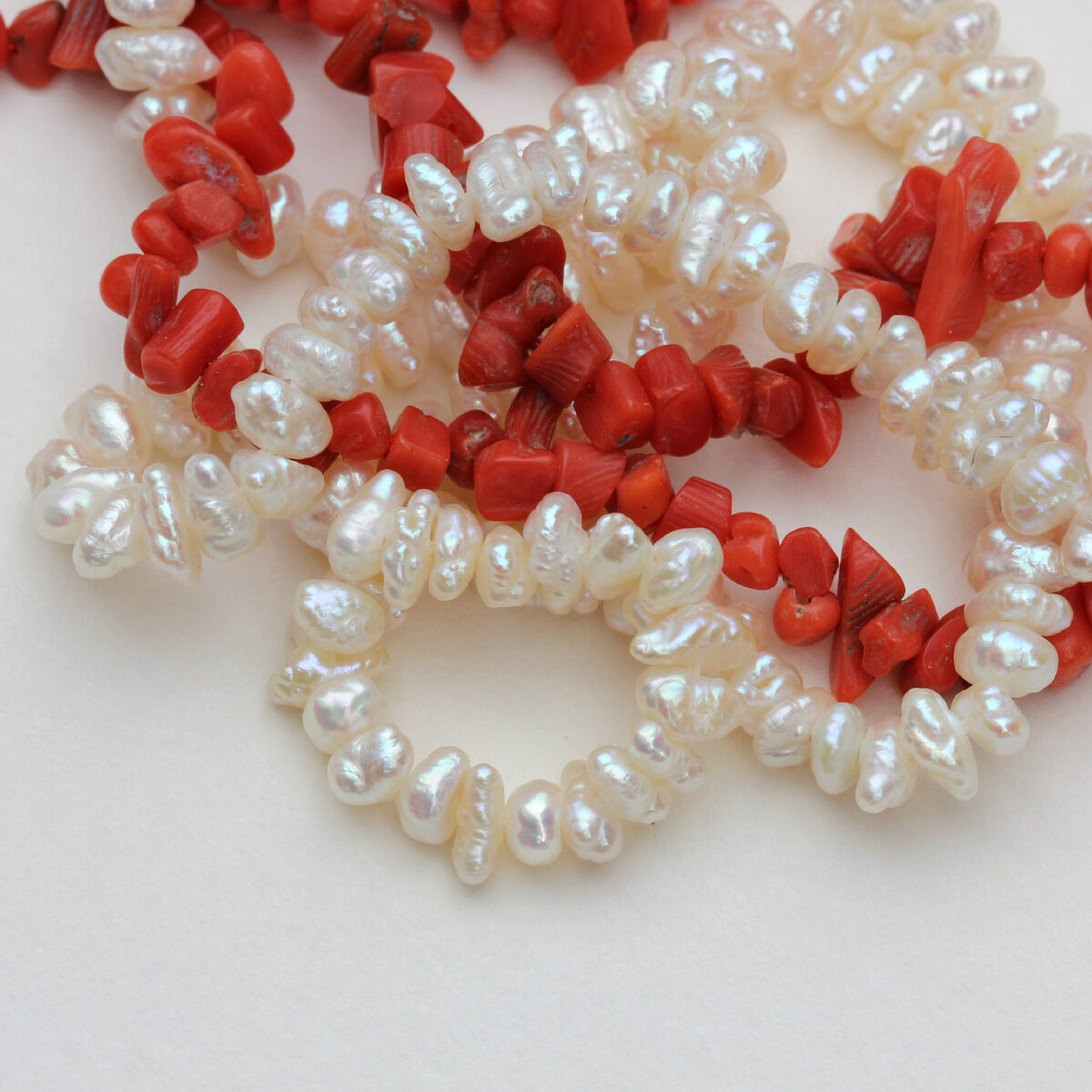 Natural red coral and pearl beads in irregular shapes, perfect for bespoke jewellery designs and handcrafted necklaces