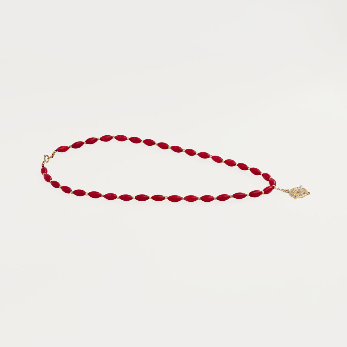 Red Velvet Necklace with gold pendant, handcrafted jewellery featuring deep red beads and elegant design