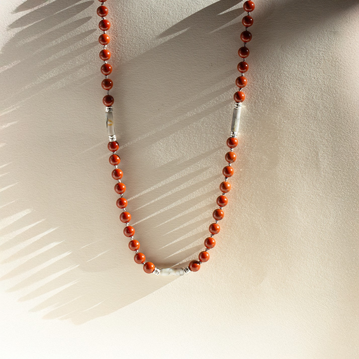 Bold red jasper men’s necklace with sterling silver tube details symbolizing grounding and strength