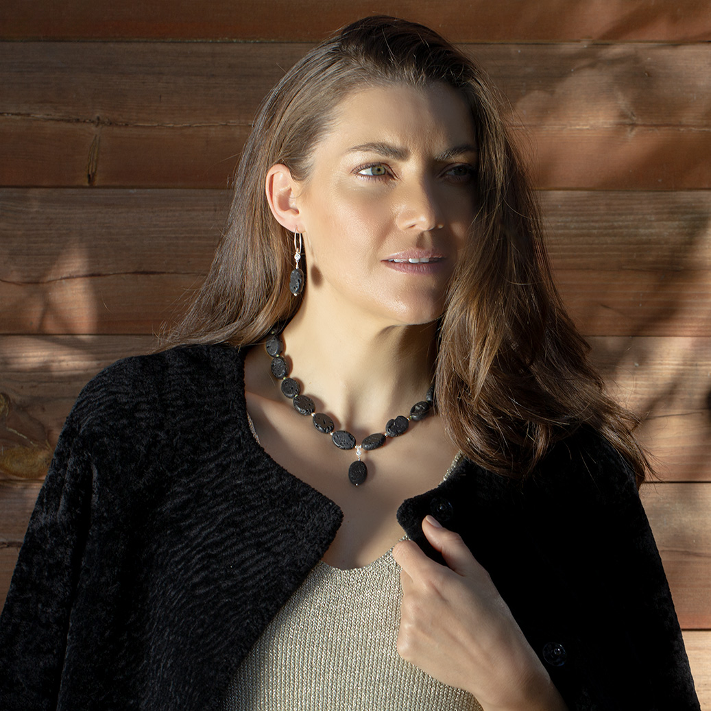 Model wearing the Midnight Lava Necklace and Earrings — handcrafted with natural black lava stones, green silk thread, cubic zirconia, and sterling silver. A bold, elegant statement set by AMONTA Jewellery.