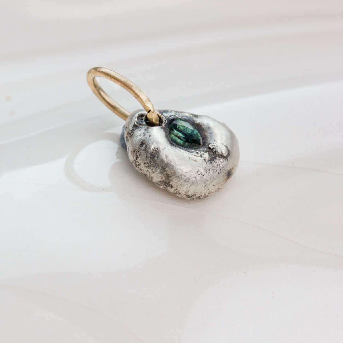 Handcrafted Argentium silver pendant with natural Australian green sapphire and 9 ct gold loop, organic sculpted design by AMONTA jewellery