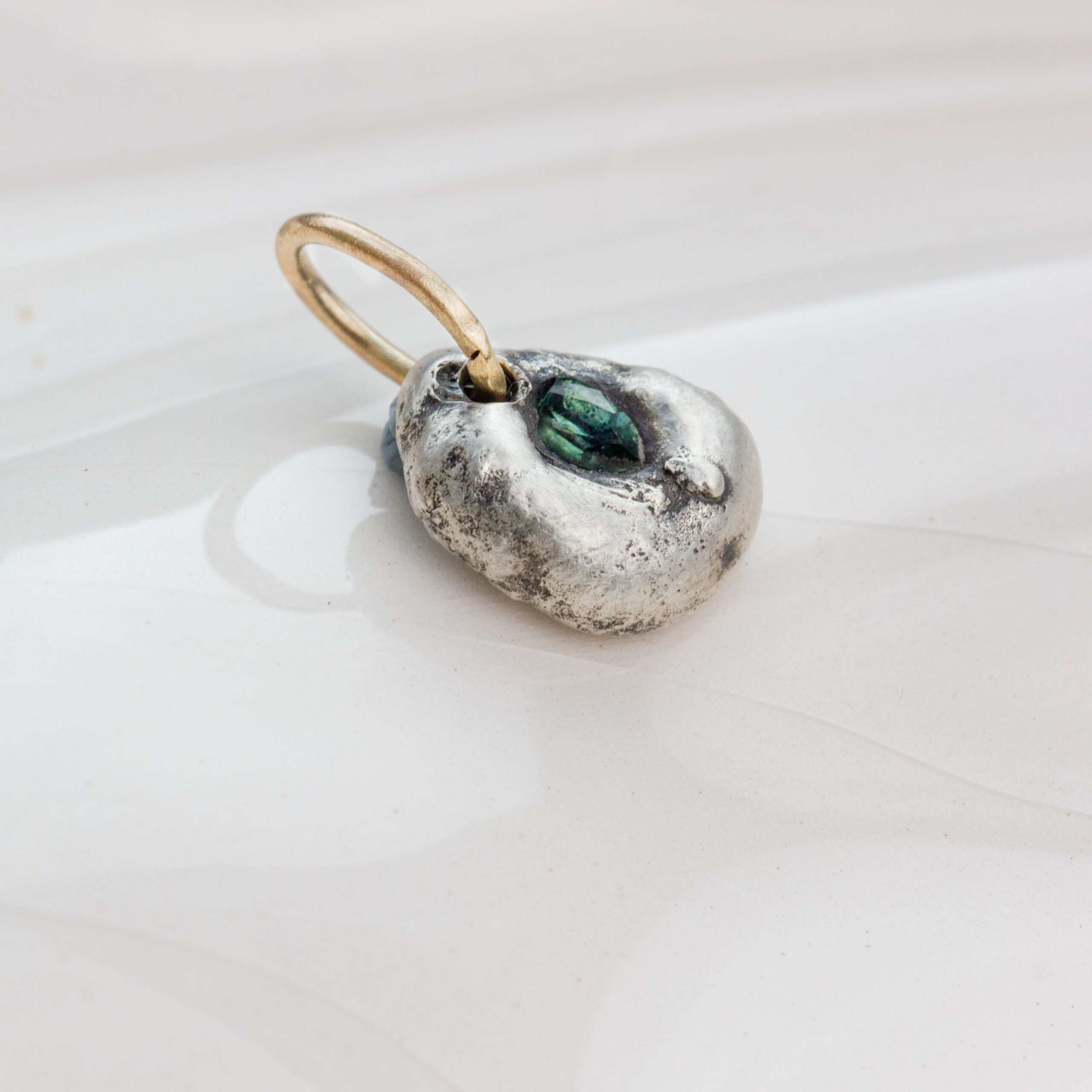 Handcrafted Argentium silver pendant with natural Australian green sapphire and 9 ct gold loop, organic sculpted design by AMONTA jewellery