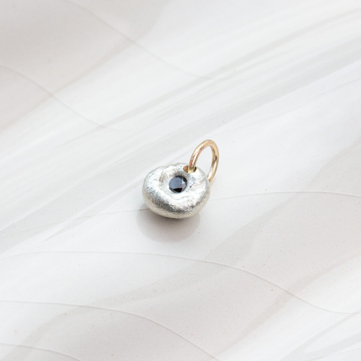 Small black diamond pendant in Argentium silver with 9 ct gold bail, handcrafted AMONTA jewellery