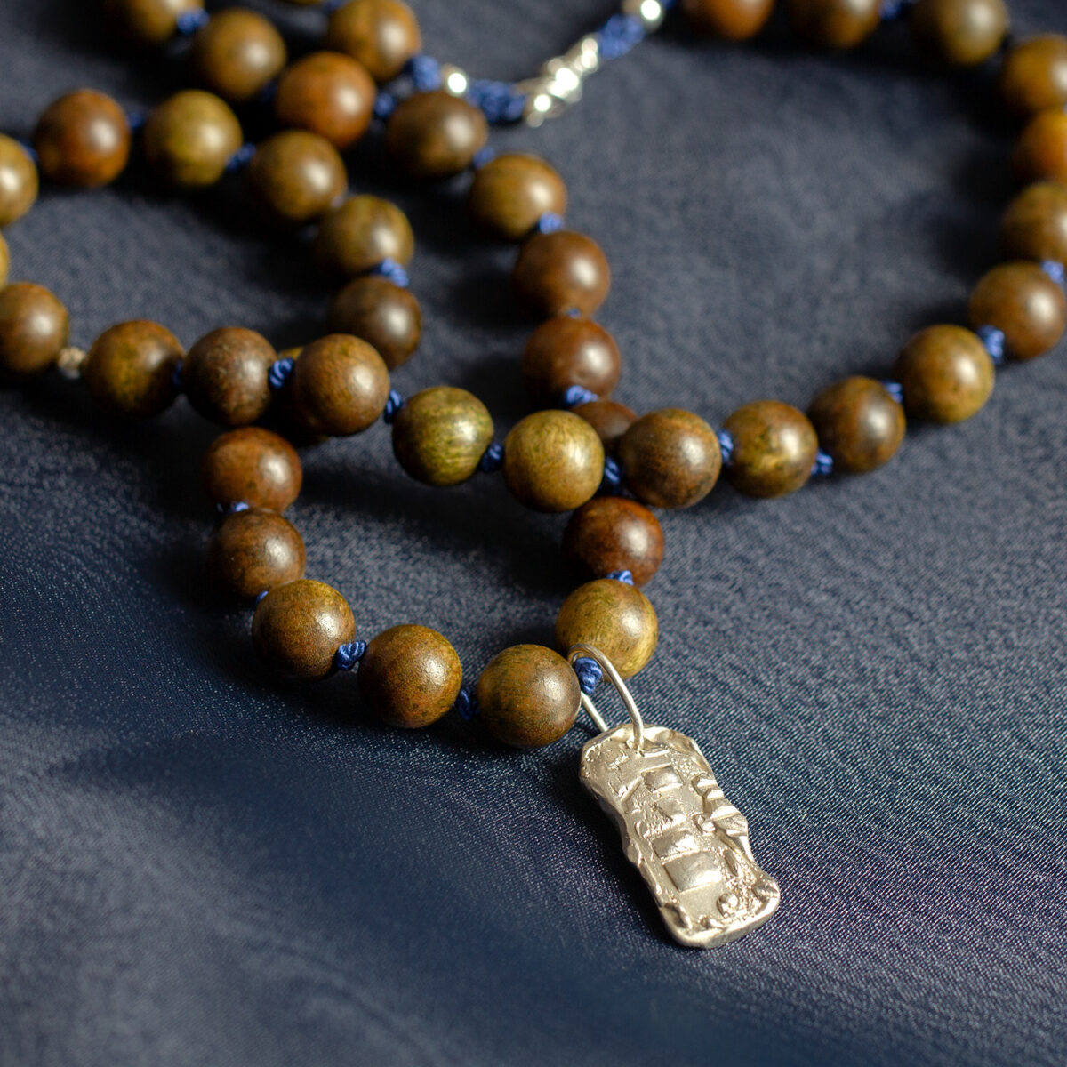 Amonta Kin sandalwood necklace with deep blue silk and fully hallmarked sterling silver pendant by AMONTA Jewellery.
